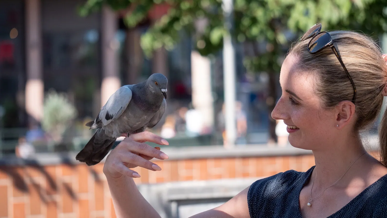 A woman holding a pigeon
